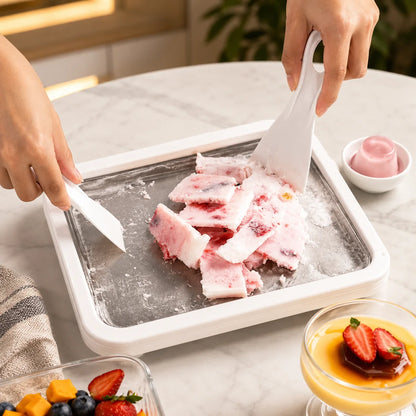 White rolled ice cream tray with strawberry dessert and white scrapers