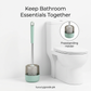 Mint toilet brush with holder beside a white toilet