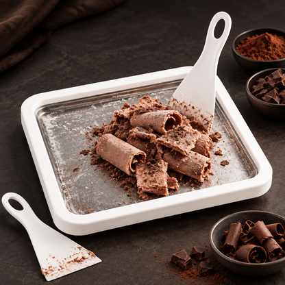 White ice cream tray with chocolate dessert and scrapers on a dark tabletop